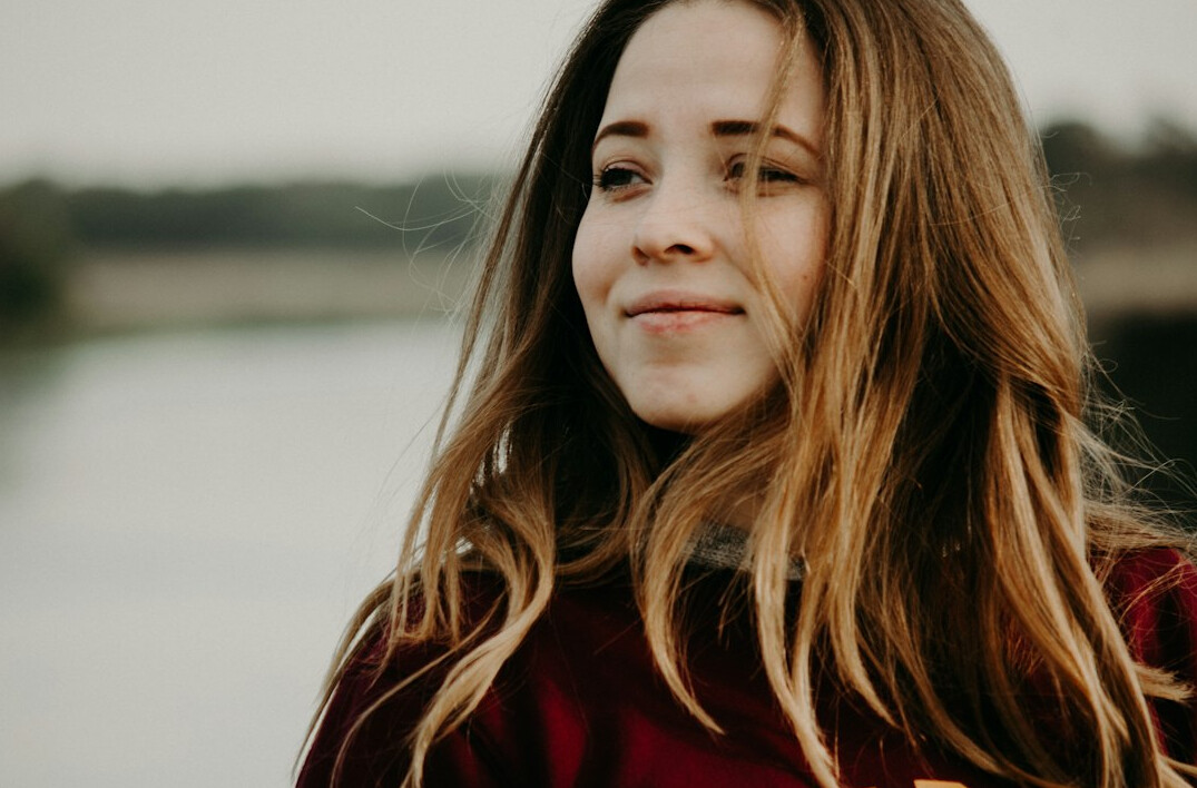Portrait of a woman with long hair smiling