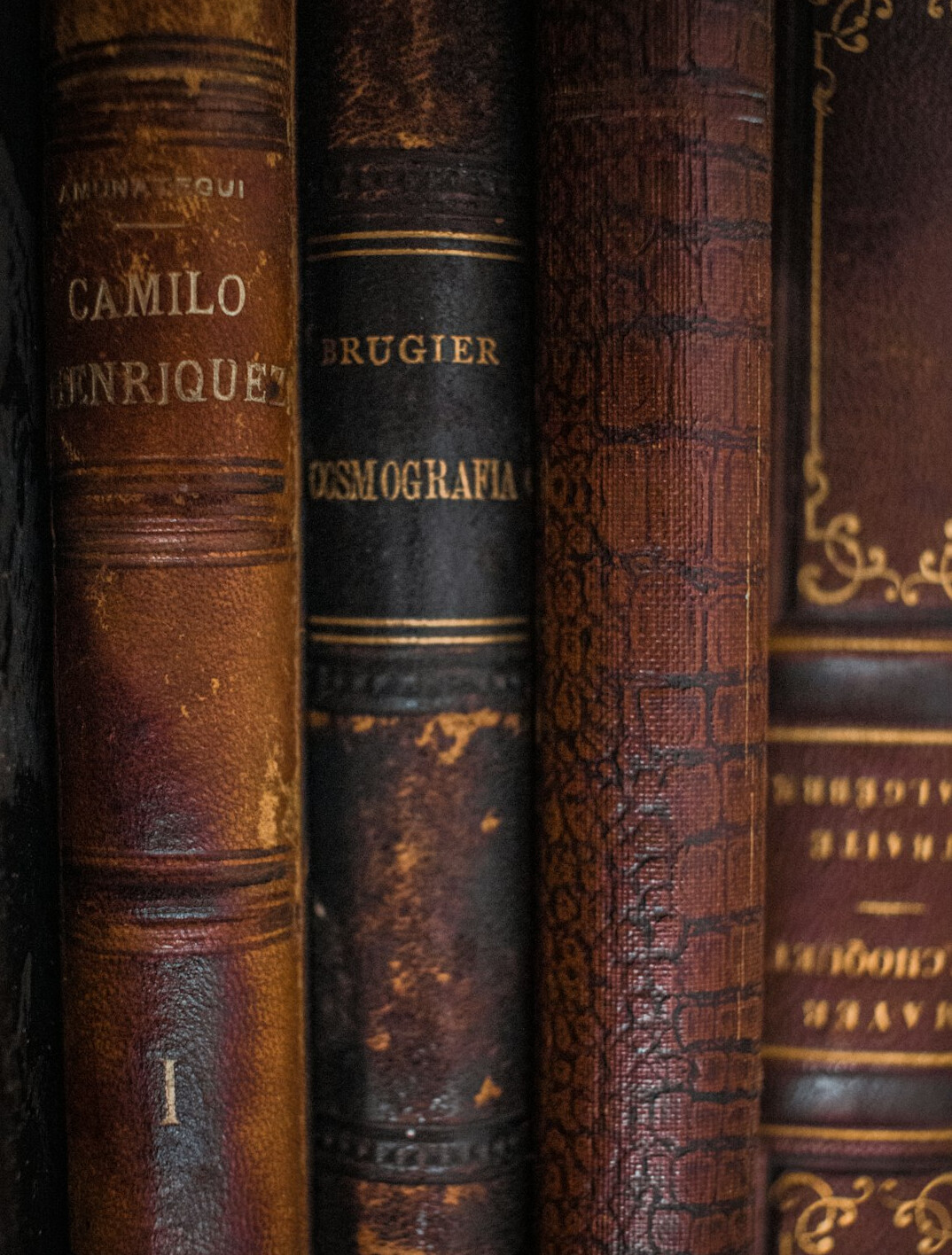 Stack of old leather-bound books and ledgers